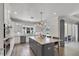 Modern kitchen with a large marble island, stainless steel appliances, and lots of natural light at 3055 Wolf Branch Rd, Mount Dora, FL 32757