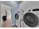The laundry room features a washer and dryer, cabinets, and an open closet at 3055 Wolf Branch Rd, Mount Dora, FL 32757