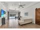 Open living room with tile floors, bright lighting and sliding glass doors overlooking pool at 3055 Wolf Branch Rd, Mount Dora, FL 32757