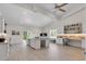 Spacious living area featuring an island, workspace, modern lighting, and large windows at 3055 Wolf Branch Rd, Mount Dora, FL 32757