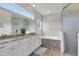 The main bathroom features double sinks, vanity, a separate tub and a tiled shower at 3055 Wolf Branch Rd, Mount Dora, FL 32757