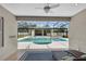 View of the screened pool area with outdoor bar as seen from an open interior patio at 3055 Wolf Branch Rd, Mount Dora, FL 32757