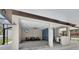 Outdoor pool house features a covered seating area, TV, and kitchenette at 3055 Wolf Branch Rd, Mount Dora, FL 32757