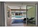 View of the screened pool area with a covered lanai, as seen from the interior patio at 3055 Wolf Branch Rd, Mount Dora, FL 32757