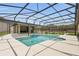 Aerial view of the pool area featuring a screened enclosure and outdoor living space at 3055 Wolf Branch Rd, Mount Dora, FL 32757