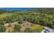 Beautiful property aerial view featuring a custom home, mature trees, and a private pool at 6905 Clayton St, Mount Dora, FL 32757