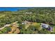 Aerial view showcases this property's proximity to the serene lake and surrounding wooded area at 6905 Clayton St, Mount Dora, FL 32757