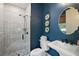 This bathroom features a toilet, sink, standing shower, and is nicely decorated with artwork at 6905 Clayton St, Mount Dora, FL 32757