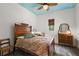 This bedroom features unique wood furniture, a ceiling fan, and light-colored walls at 6905 Clayton St, Mount Dora, FL 32757