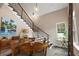 This dining room features a wood table with chairs, as well as a large staircase at 6905 Clayton St, Mount Dora, FL 32757