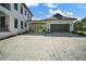 Spacious driveway leading to a modern garage with ample parking and a covered area at 6905 Clayton St, Mount Dora, FL 32757
