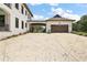 Spacious driveway leading to a detached garage with a porte-cochere, perfect for car enthusiasts and storage at 6905 Clayton St, Mount Dora, FL 32757
