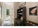 Hallway with a view of the outside, an antique desk, and a horse statue at 6905 Clayton St, Mount Dora, FL 32757