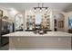 Kitchen island with decorative light fixtures and decorative shelving at 6905 Clayton St, Mount Dora, FL 32757