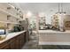 Bright kitchen featuring stainless steel appliances, stylish shelving, and a neutral color scheme, creating a welcoming culinary space at 6905 Clayton St, Mount Dora, FL 32757