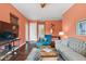 A bright living room with hardwood floors, a decorative rug, and ample natural light provides a welcoming atmosphere at 6905 Clayton St, Mount Dora, FL 32757