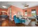 A cozy living room features hardwood floors, a decorative ceiling fan, and comfortable seating arrangements at 6905 Clayton St, Mount Dora, FL 32757