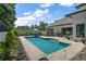 Inviting backyard pool surrounded by a beautifully landscaped patio and lush greenery at 6905 Clayton St, Mount Dora, FL 32757