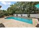 Relaxing backyard pool with lush landscaping and tiled patio, perfect for outdoor entertaining at 6905 Clayton St, Mount Dora, FL 32757