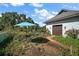 Well-maintained yard showcasing lush landscaping and a charming outdoor dining area at 6905 Clayton St, Mount Dora, FL 32757