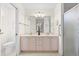 Bright bathroom with double sinks, a large mirror, and a glass-enclosed shower at 8097 Se 174Th Belhaven Loop, The Villages, FL 32162