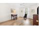 Inviting bedroom with hardwood floors, a window with curtains, and classic decor at 8097 Se 174Th Belhaven Loop, The Villages, FL 32162
