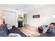 Comfortable bedroom with hardwood floors, a ceiling fan, and a large couch at 8097 Se 174Th Belhaven Loop, The Villages, FL 32162
