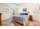 Cozy bedroom with a plush bed, a ceiling fan, and natural light from a large window at 8097 Se 174Th Belhaven Loop, The Villages, FL 32162