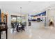 Open dining area showcasing a pendant chandelier, tile flooring, and access to outdoor views at 8097 Se 174Th Belhaven Loop, The Villages, FL 32162