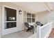 Cozy front porch with seating, offering a welcoming and relaxing outdoor space at 8097 Se 174Th Belhaven Loop, The Villages, FL 32162