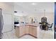 Open-concept kitchen features a large island connecting the kitchen, living room, and dining area at 8097 Se 174Th Belhaven Loop, The Villages, FL 32162
