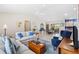 Bright living room featuring neutral walls, a ceiling fan, tile floors, and comfortable seating at 8097 Se 174Th Belhaven Loop, The Villages, FL 32162