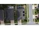 Aerial view of the property featuring a dark roof, screened-in pool, and well-manicured lawn in a neighborhood setting at 2504 Cavender Creek Rd, Minneola, FL 34715