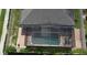 Aerial view of a screened-in pool, brick paver deck, and manicured landscaping at 2504 Cavender Creek Rd, Minneola, FL 34715