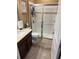 Bathroom featuring a tiled walk-in shower with glass doors, toilet, and vanity at 2504 Cavender Creek Rd, Minneola, FL 34715