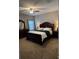 Well-lit bedroom featuring a comfortable bed, matching nightstands, and a ceiling fan at 2504 Cavender Creek Rd, Minneola, FL 34715