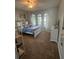 Cozy bedroom featuring plush carpet, ceiling fan, and abundant natural light from the three windows at 2504 Cavender Creek Rd, Minneola, FL 34715