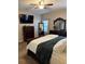 Cozy bedroom with a dresser, mirror, and comfortable bed with soft, natural light from the window at 2504 Cavender Creek Rd, Minneola, FL 34715