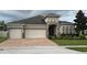 Charming single-story home featuring a three-car garage, brick driveway, and well-maintained landscaping at 2504 Cavender Creek Rd, Minneola, FL 34715