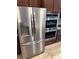 Bright kitchen featuring stainless steel refrigerator and double ovens built into the cabinets at 2504 Cavender Creek Rd, Minneola, FL 34715