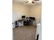 Cozy carpeted home office provides ample workspace with a corner desk setup and neutral wall colors at 2504 Cavender Creek Rd, Minneola, FL 34715