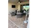 Covered patio with comfortable seating around a table and an outdoor television at 2504 Cavender Creek Rd, Minneola, FL 34715