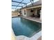 Inviting screened-in pool with brick paver deck and outdoor lounge area, creating a perfect backyard retreat at 2504 Cavender Creek Rd, Minneola, FL 34715
