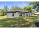 Exterior view showcasing the backyard with a well-maintained lawn, perfect for outdoor enjoyment at 10033 Canterbury Dr, Leesburg, FL 34788
