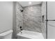 Bathroom features white marble-look tile in the shower/tub at 10033 Canterbury Dr, Leesburg, FL 34788