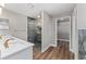 Bathroom featuring double sinks, stylish shower, and a walk in closet at 10033 Canterbury Dr, Leesburg, FL 34788