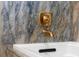 Close up of bath tub with gold fixtures and marble-look surround at 10033 Canterbury Dr, Leesburg, FL 34788