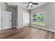 Bedroom with neutral walls, wood floor, white trim and window at 10033 Canterbury Dr, Leesburg, FL 34788