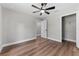 Bedroom featuring wood floors, natural light from the window, walk in closet and a modern ceiling fan at 10033 Canterbury Dr, Leesburg, FL 34788