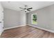 Bedroom featuring wood floors, natural light from the window and a modern ceiling fan at 10033 Canterbury Dr, Leesburg, FL 34788